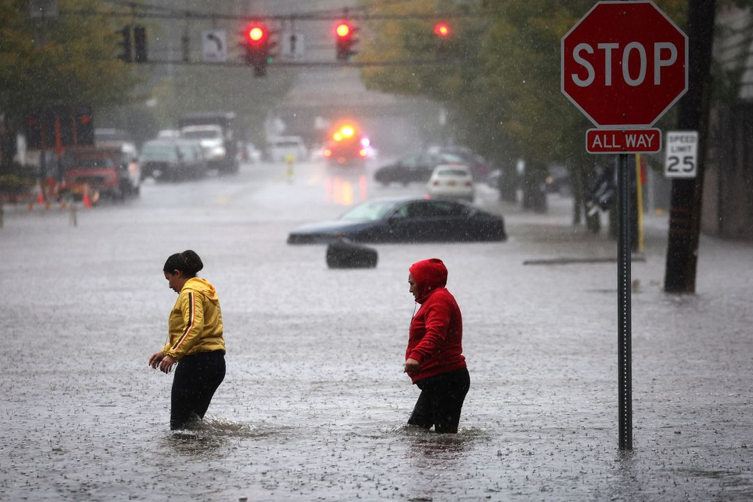 Residents walk through floodwaters during a heavy rain storm in the New York City suburb of Mamaroneck in Westchester County, 29 September 2023. Photo: Mike Segar / REUTERS