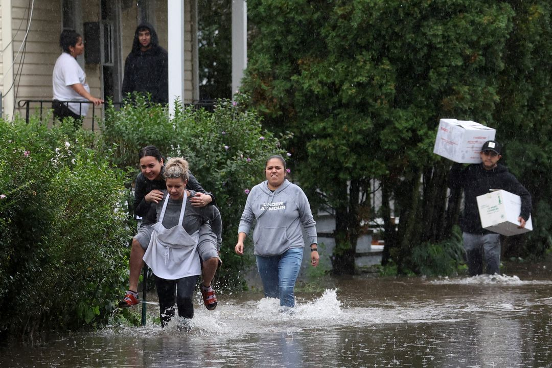 Residents walk through floodwaters during a heavy rainstorm in the New York City suburb of Mamaroneck in Westchester County, New York, 29 September 2023. Photo: Mike Segar / REUTERS