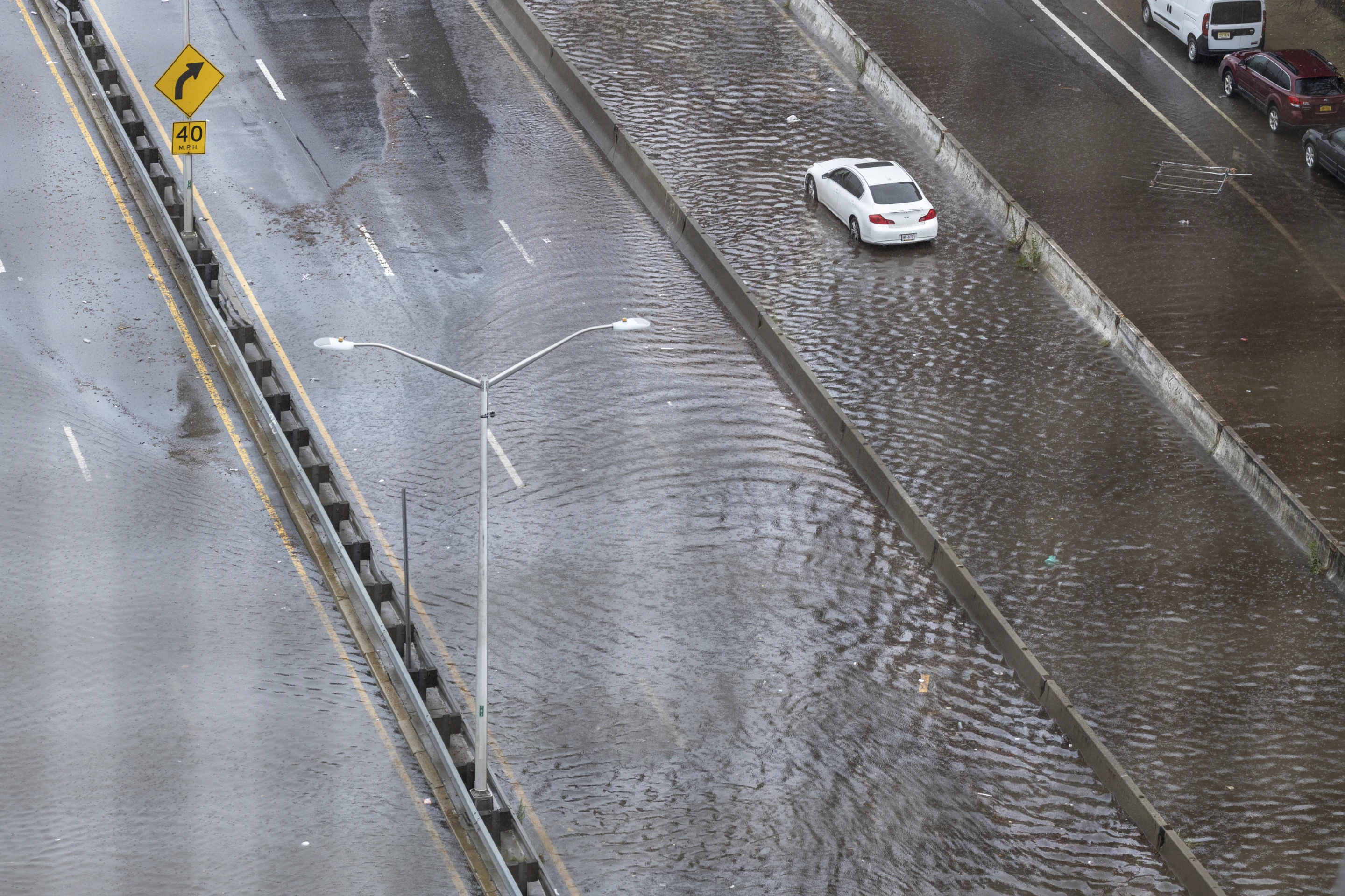 An abandoned car sits in flood waters on the FDR highway in the Lower East Side of Manhattan on Friday, 29 September 2023 in New York. A potent rush-hour rainstorm swamped the New York metropolitan area on Friday, shutting down some subways and commuter railroads, flooding streets and highways, and delaying flights into LaGuardia Airport. Photo: Stefan Jeremiah / AP Photo