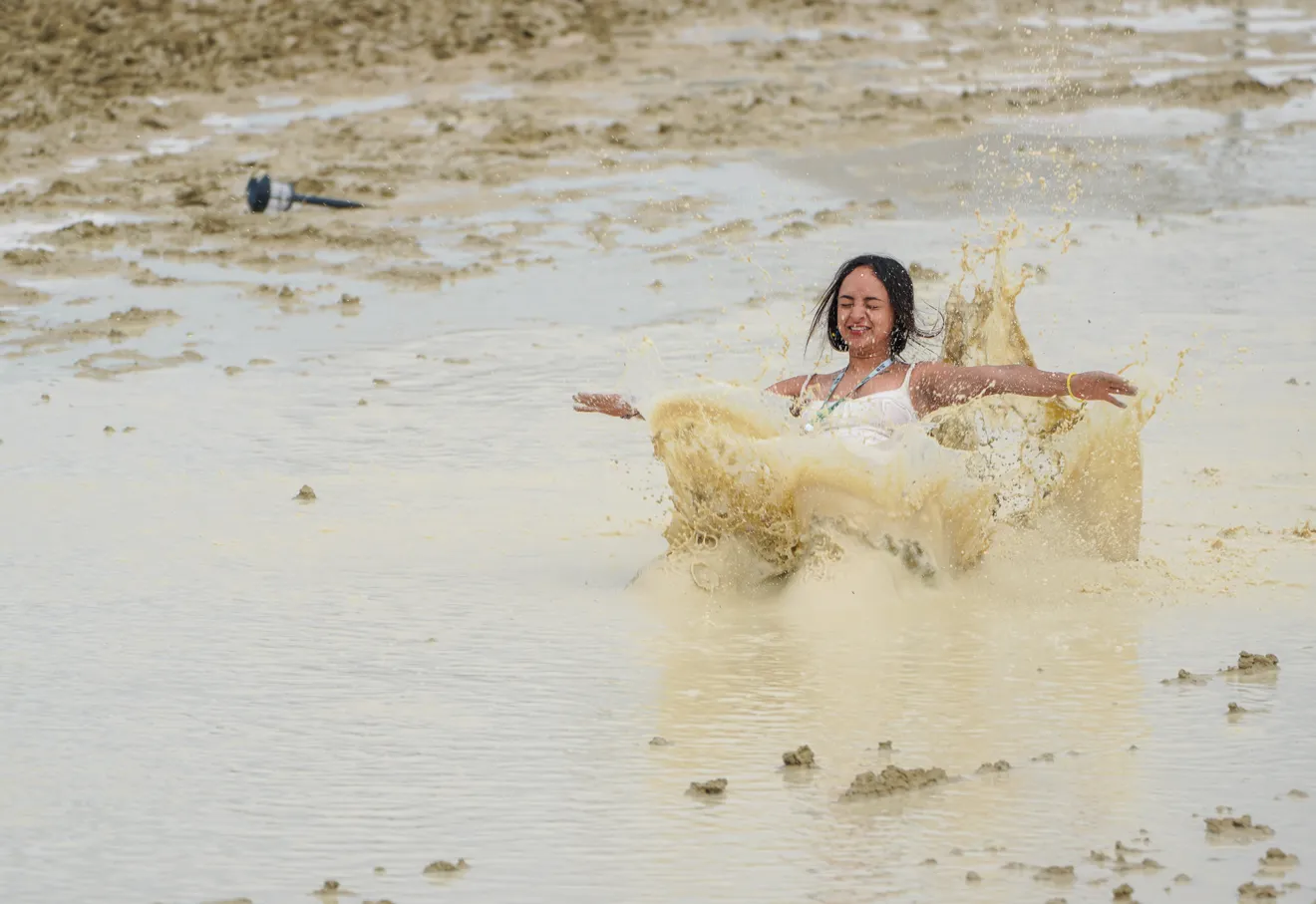 Shai Peza of Chicago frolics in the mud and water at the flooded Burning Man festival on 2 September 2023, after a rainstorm flooded the site and stranded thousands. Photo: Trevor Hughes / USA TODAY