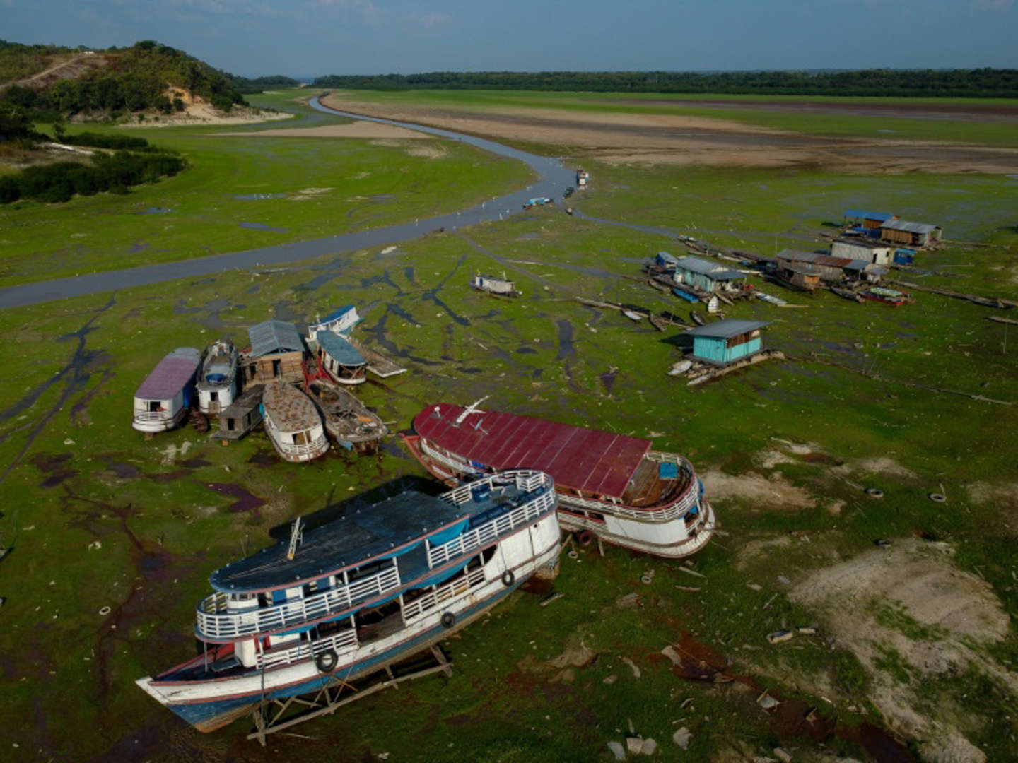 Boats stranded in the mud of the parched Lago Aleixo amid a drought in the Amazonas state of Brazil in 2023. Photo: Michael Dantas / AFP