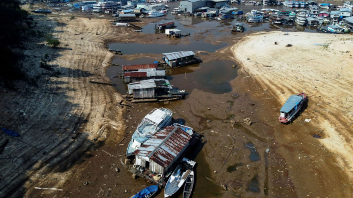 Aerial view of boats stranded in the mud of the parched Rio Negro amid a drought in the Amazonas state of Brazil on 29 September 2023. Photo: Michael Dantas / AFP