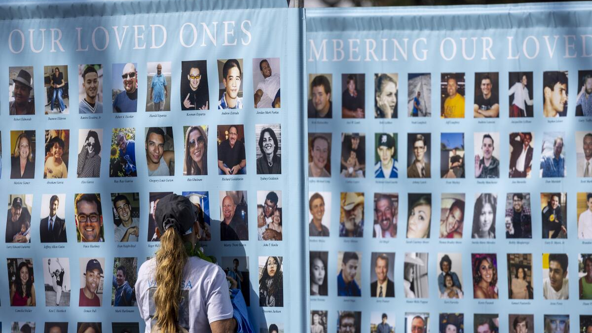 A woman presses her face against a photo on a memorial poster during an event to raise awareness and funds for Didi Hirsch Suicide Prevention Center in Los Angeles in October 2023. Photo: Allen J. Schaben / Los Angeles Times