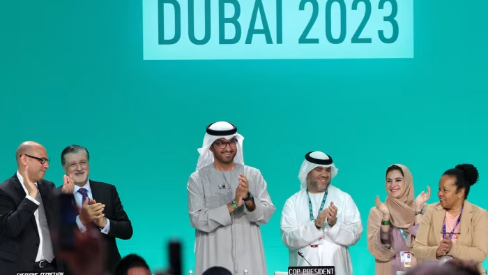 COP28 president Sultan al-Jaber, third left, led the applause for what he said was a consensus agreement at the UN climate summit in Dubai. Photo: AFP / Getty Images