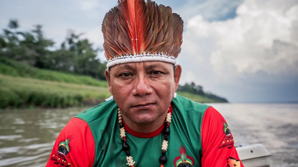 Oliveira Tikuna, of Bom Jesus de Igapo Grande in the Amazon rainforest, sitting in a boat. Tikuna says the 2023 drought has been a wake up call. Photo: Paul Harris / BBC