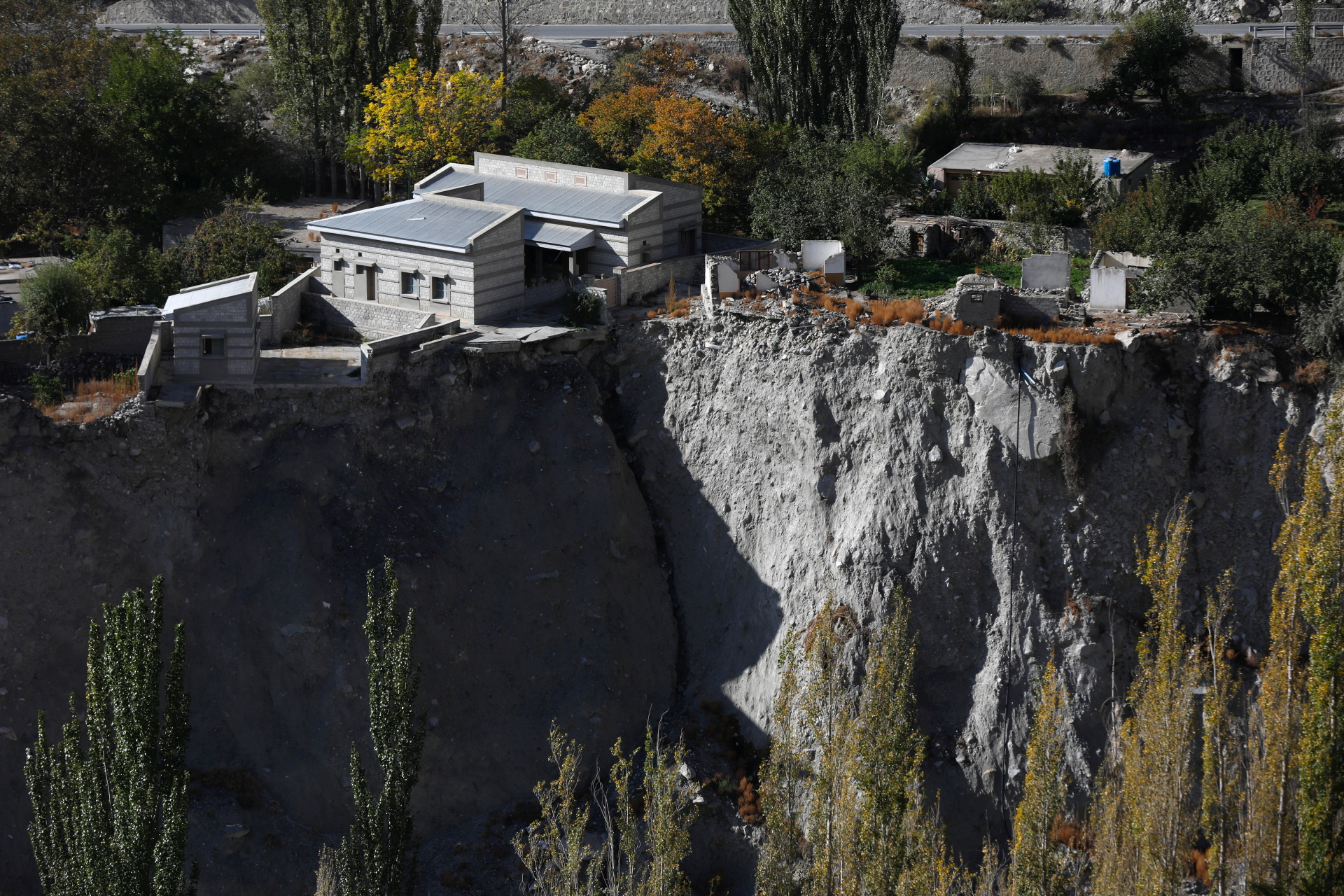A community hall and houses show signs of damage after a Glacial Lake Outburst Flooding (GLOF) incident occurred from the nearby Shisper glacier, in Hassanabad village, Pakistan, 10 October 2023. Photo: Akhtar Soomro / REUTERS