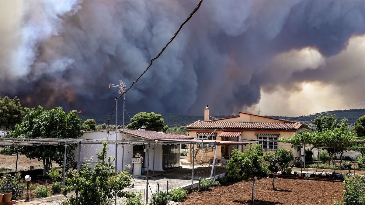 Thick black smoke fills the air near the settlement of Pournari, as wildfires engulf the area of Magoula in Greece on 18 July 2023. Photo: Spyros Bakalis / AFP / Getty