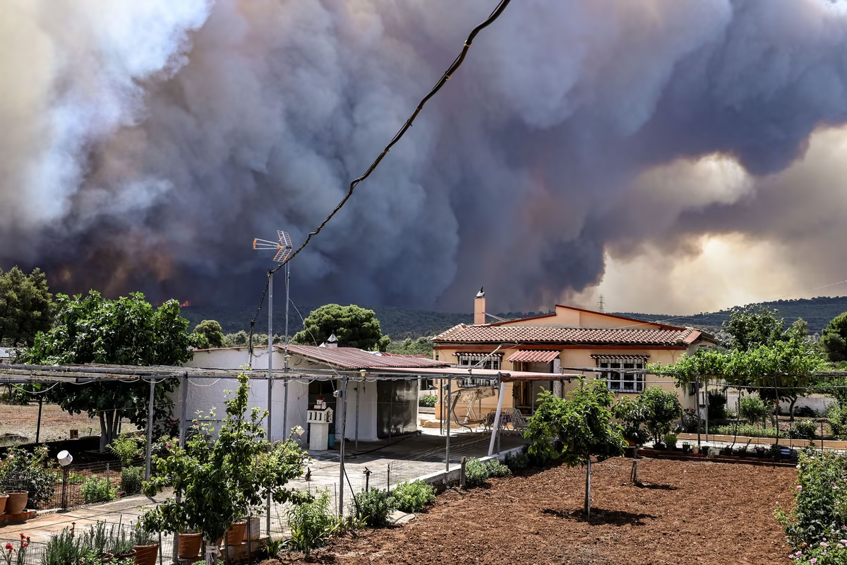 Thick black smoke fills the air near the settlement of Pournari, as wildfires engulf the area of Magoula in Greece on 18 July 2023. Photo: Spyros Bakalis / AFP / Getty