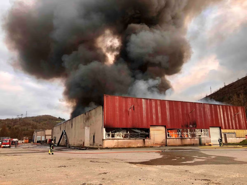 Firefighters respond as a warehouse burns, which houses lithium batteries and is owned by French recycling group SNAM, in Viviez, north of Toulouse, France, 17 February 2024 in this image obtained from social media. Photo: Adeba / REUTERS