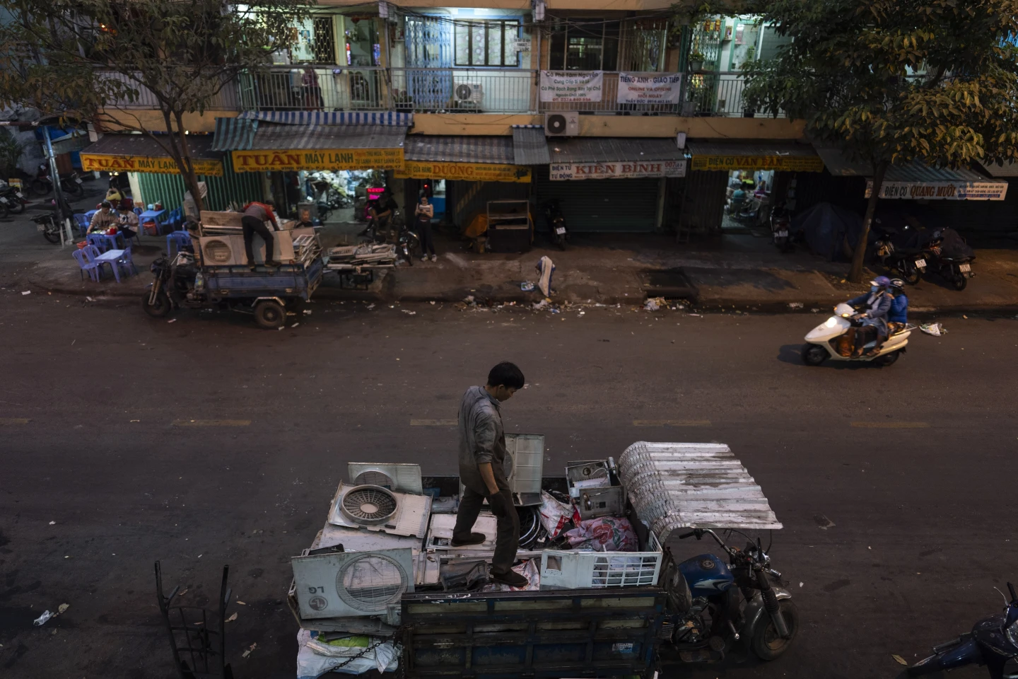 Waste workers load casings of various home appliances onto their trucks in Nhat Tao market, the largest informal recycling market in Ho Chi Minh City, Vietnam, Monday, 29 January 2024. Less than a quarter of electronic waste was properly collected and recycled in 2022. Photo: Jae C. Hong / AP Photo