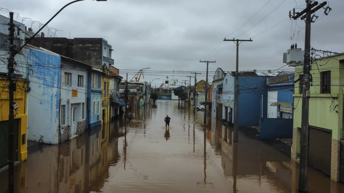 A man wades through an area flooded by heavy rains, in Porto Alegre, Rio Grande do Sul state, Brazil, 3 May 2024. Photo: Carlos Macedo / AP Photo