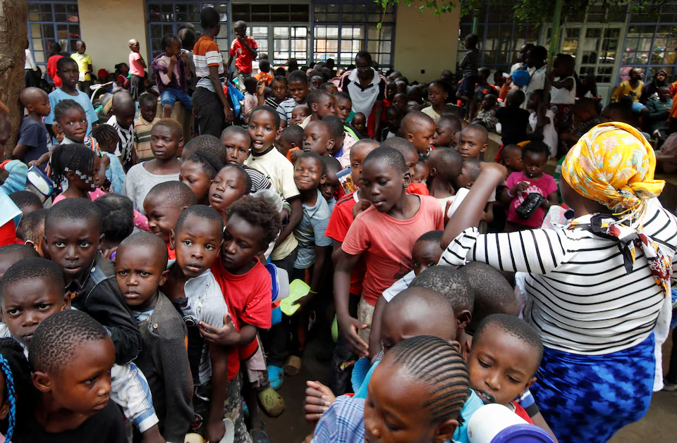 Displaced children queue for food rations at a rescue centre after the Nairobi river burst its banks and destroyed their homes within the Mathare valley settlement in Nairobi, Kenya, 30 April 2024. Photo: Monicah Mwangi / REUTERS
