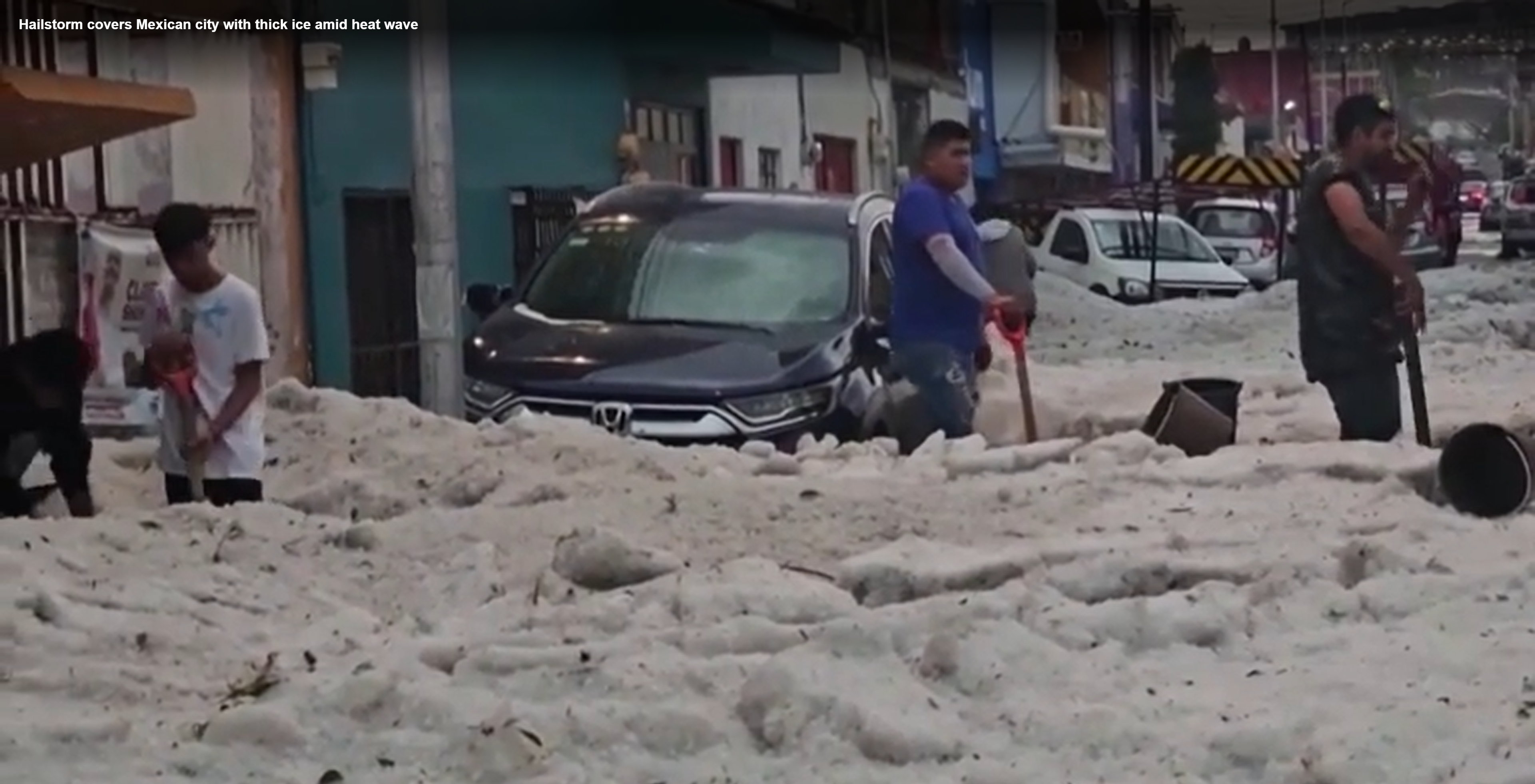 Residents shovel thick layers of ice after a surprise hailstorm hit Puebla, Mexico on 24 May 2024. Photo: Reuters