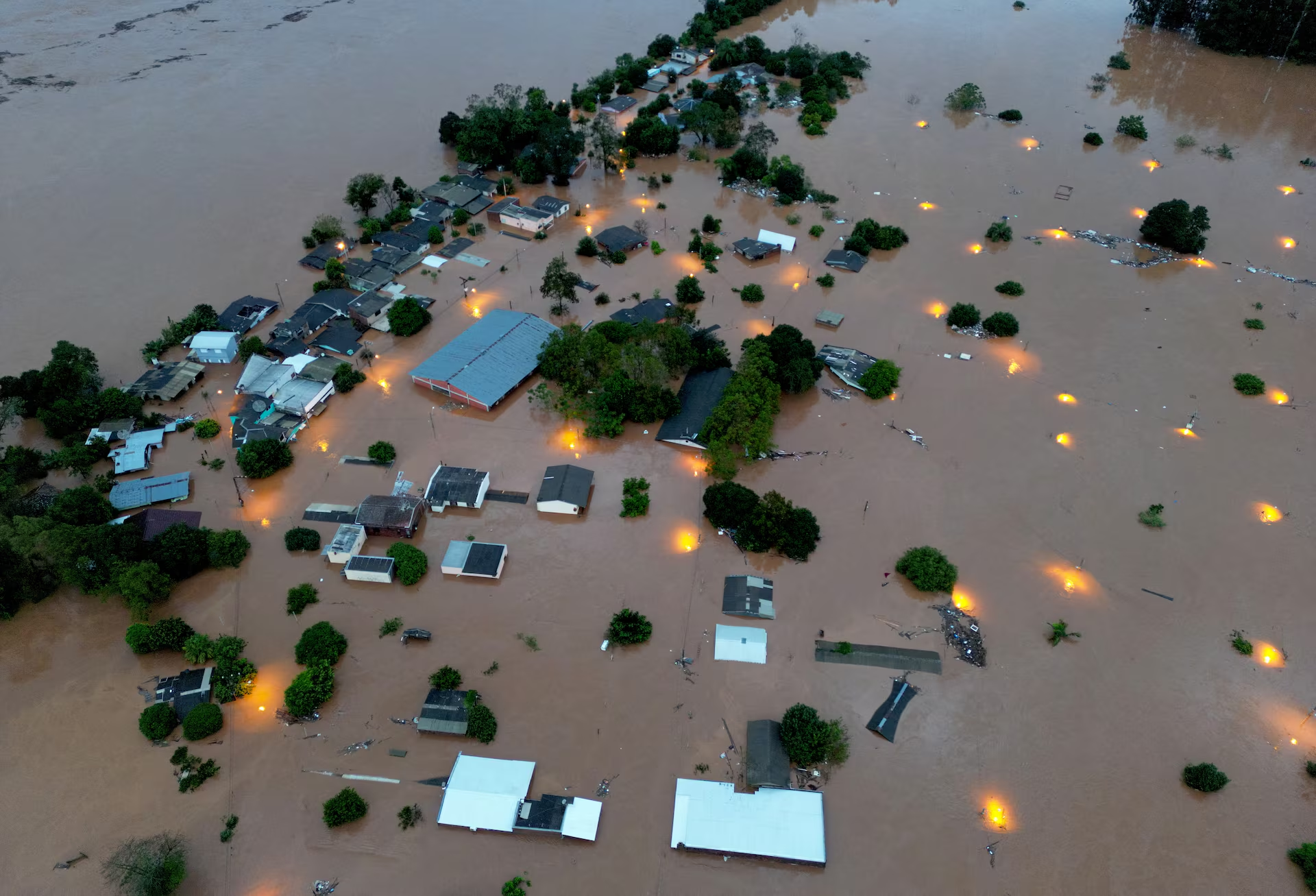 A drone view shows houses in the flooded area next to the Taquari River during heavy rains in the city of Encantado in Rio Grande do Sul, Brazil, 1 May 2024. Photo: Diego Vara / REUTERS