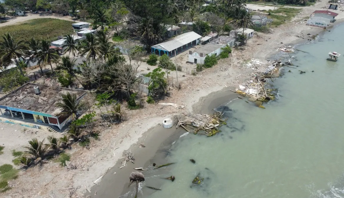 Aerial view showing houses destroyed by rising sea levels and coastal erosion associated with climate change, in the community of El Bosque in Nuevo Centla, Tabasco state, Mexico. About 700 people once lived in El Bosque, which sits on a small peninsula jutting out into the Gulf of Mexico. According to environmental group Greenpeace, El Bosque is the first community in Mexico to be officially recognised as displaced by climate change. Photo: Yuri Cortez / AFP