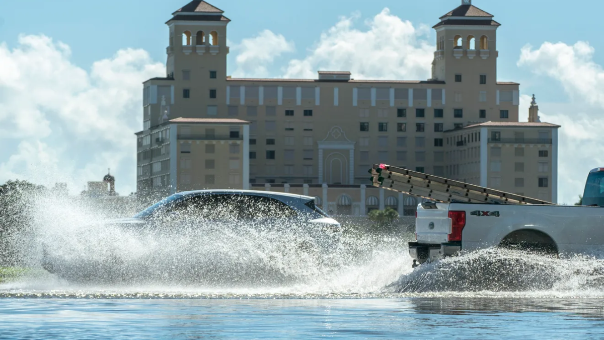 Motorists splash through the water along North Flagler Drive during king tide flooding in West Palm Beach, Florida on 30 September 2023. Photo: Greg Lovett / The Palm Beach Post