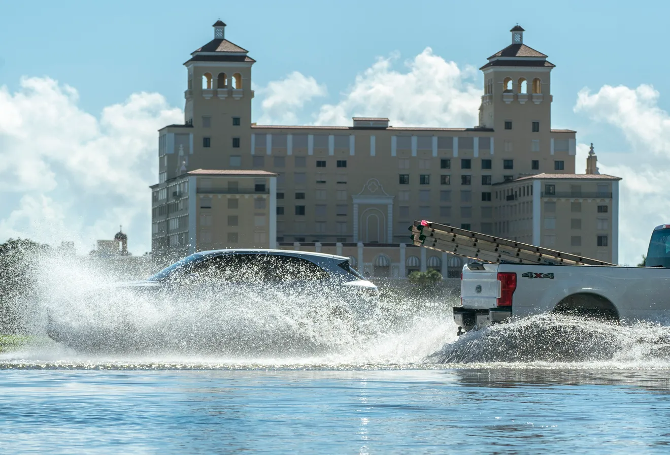 Motorists splash through the water along North Flagler Drive during king tide flooding in West Palm Beach, Florida on 30 September 2023. Photo: Greg Lovett / The Palm Beach Post