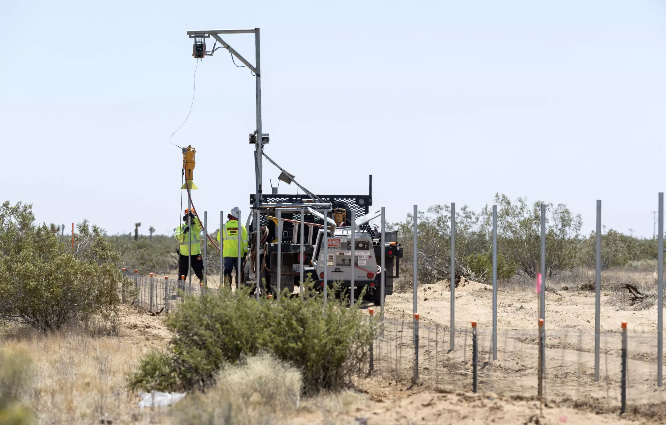 Workers install a fence around the Aratina solar project in Boron. Thousands of protected Joshua trees just outside this desert town, including many thought to be a century old, will be cut down to make way for a sprawling solar project. Photo: Myung J. Chun / Los Angeles Times