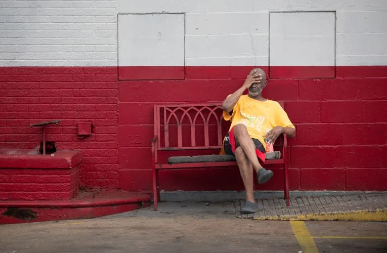 A man sits on a bench during a heatwave in New Orleans on Tuesday, 8 August 2023. Photo: David Grunfeld / The Times-Picayune / NOLA.com