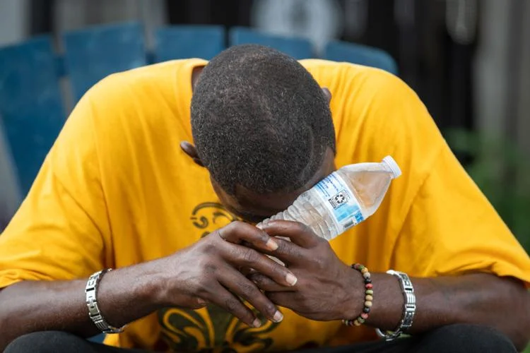 Ernest Miller uses a cold bottle of water to try and stay cool during a heatwave in New Orleans on Tuesday, 8 August 2023. Photo: David Grunfeld / The Times-Picayune / NOLA.com