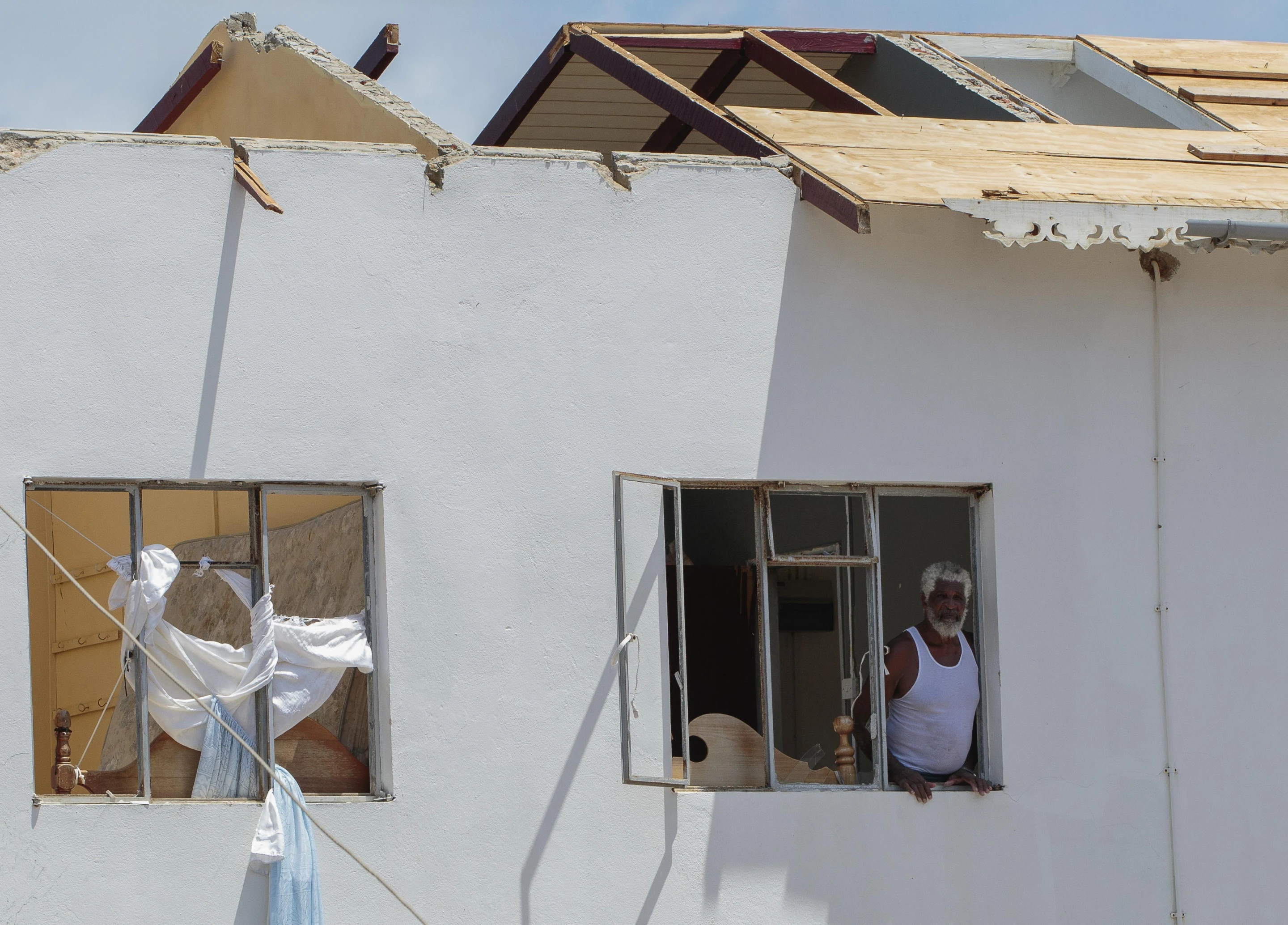 A man looks out of the window of his home, which was destroyed by Hurricane Beryl in Clifton, Union Island, St. Vincent and the Grenadines, Thursday, 4 July 2024. Photo: Lucanus Ollivierre / AP Photo