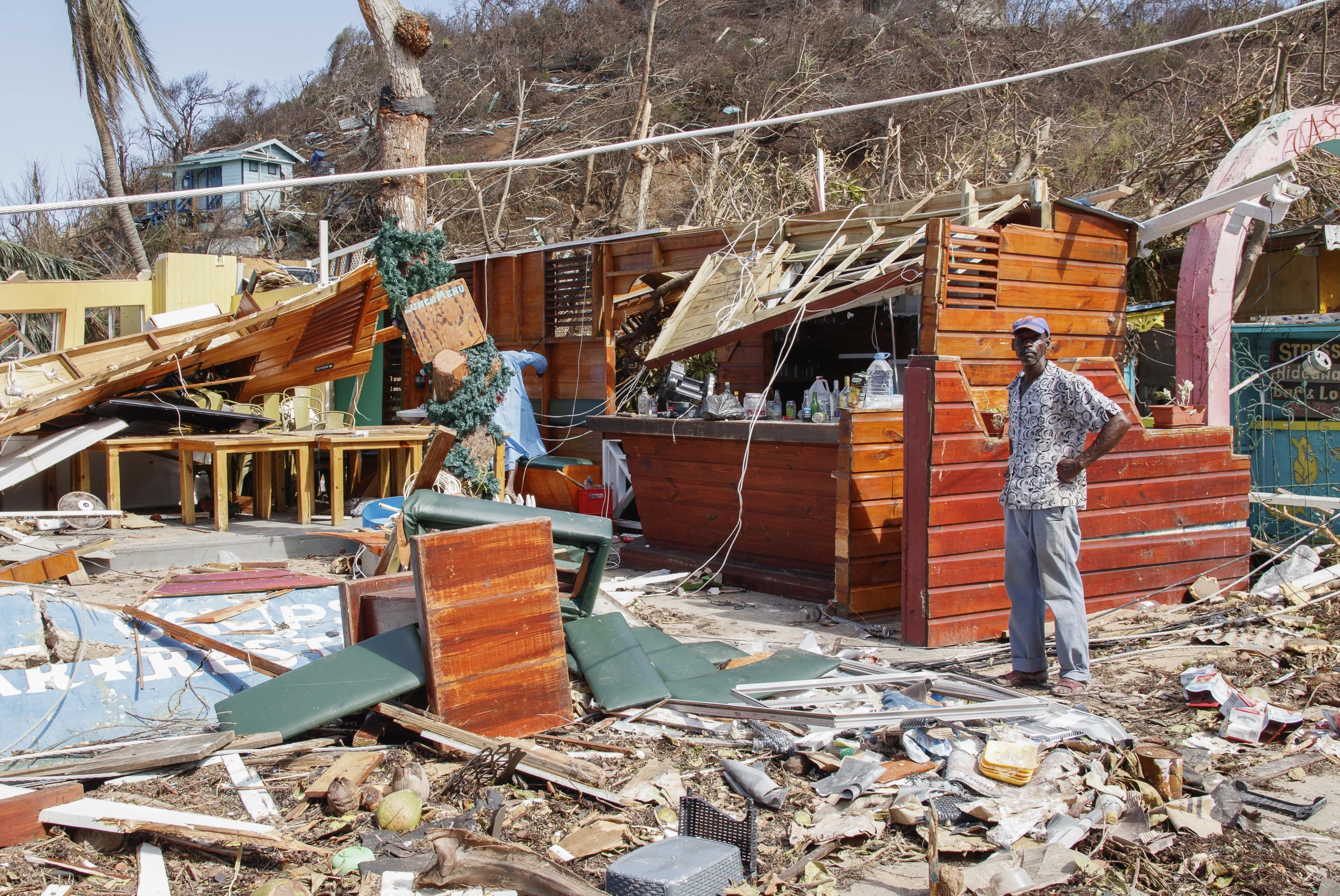 A man stands next to a business destroyed by Hurricane Beryl in Clifton, Union Island, St. Vincent and the Grenadines, Thursday, 4 July 2024. Photo: Lucanus Ollivierre / AP Photo