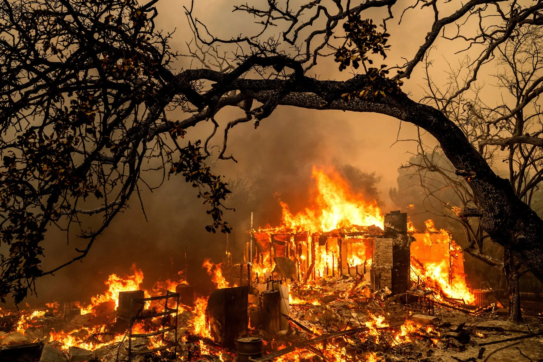 Flames consume a home on Bessie Lane as the Thompson Fire burns in Oroville, California, Tuesday, 2 July 2024. An extended heat wave blanketing Northern California resulted in red flag fire warnings and power shutoffs. Photo: Noah Berger / AP Photo