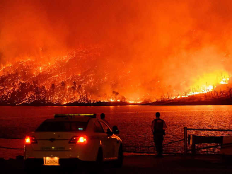 Law enforcement members watch as the Thompson fire burns over Lake Oroville in Oroville, California on 2 July 2024. Photo: Josh Edelson / AFP / Getty Images