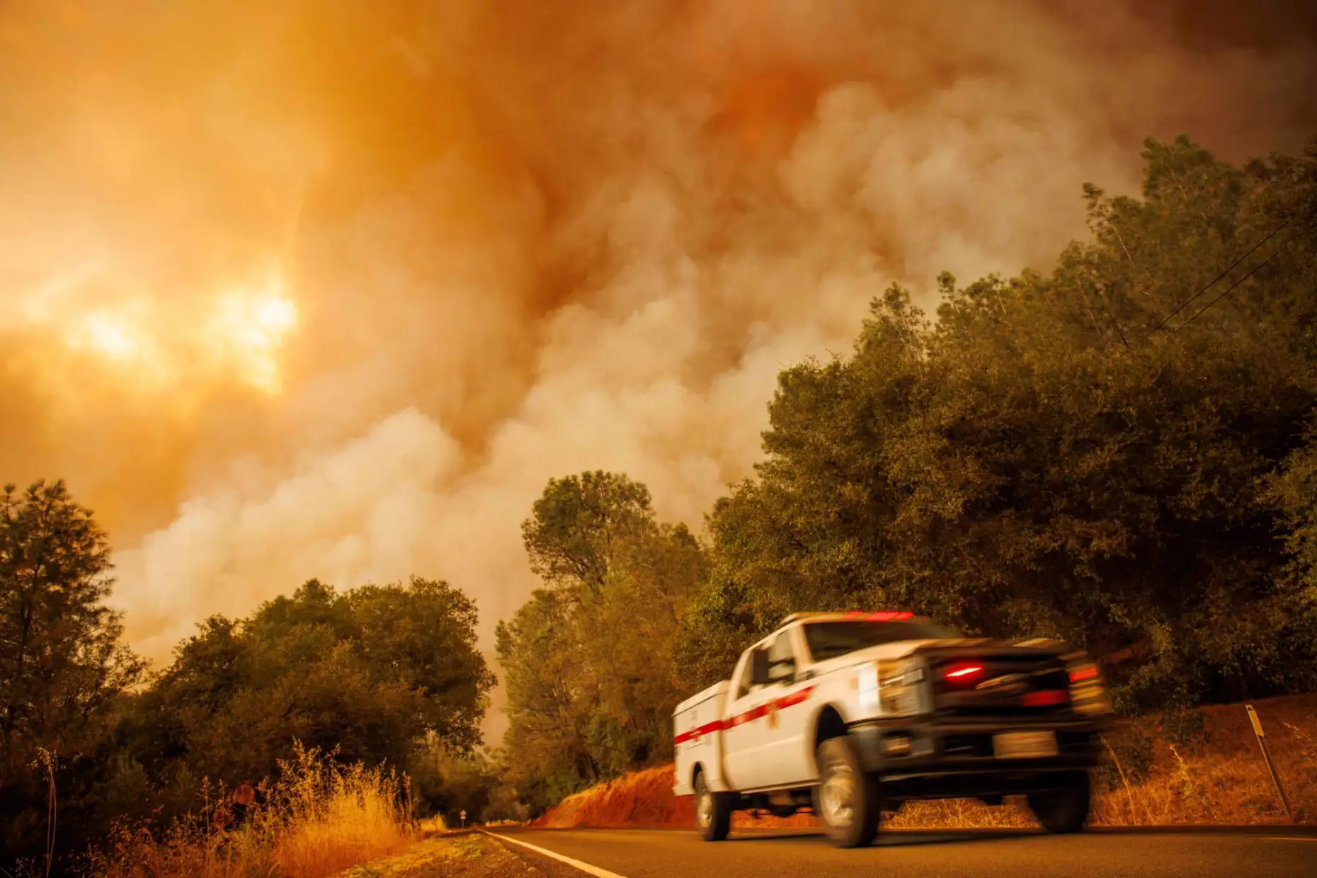 A firetruck passes as the Thompson Fire burns, Tuesday, 2 July 2024, in Oroville, California. Photo: Ethan Swope / AP