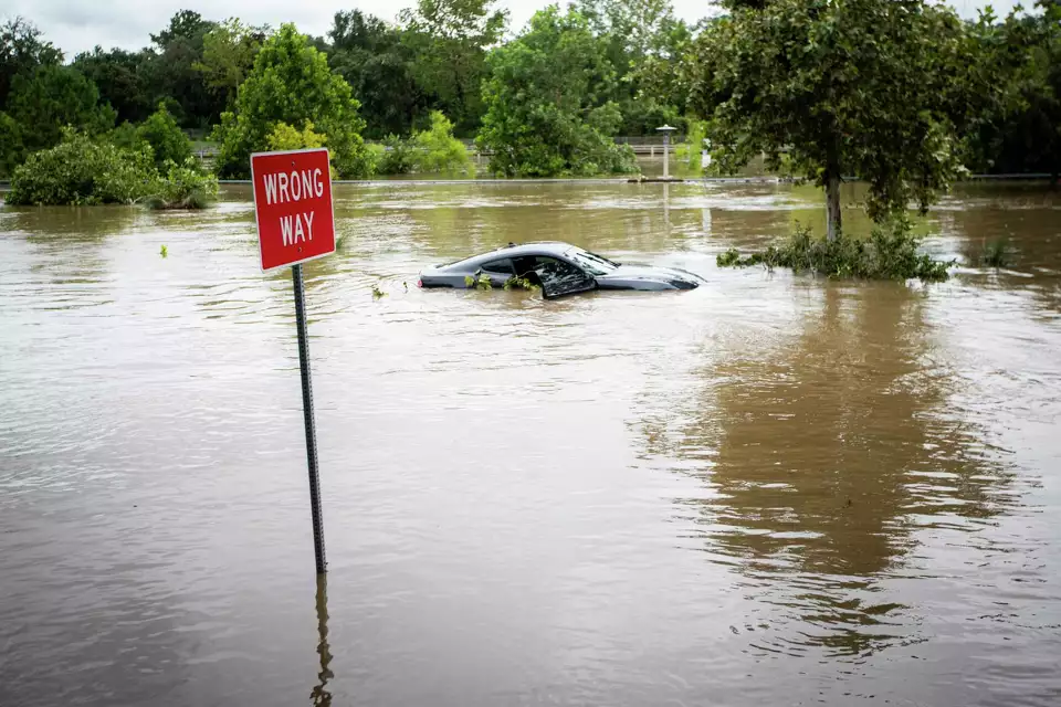 A car submerged on Allen Parkway due to Buffalo Bayou flooding after Beryl made landfall early morning Monday, 8 July 2024, in Houston. Photo: Ishika Samant / Houston Chronicle