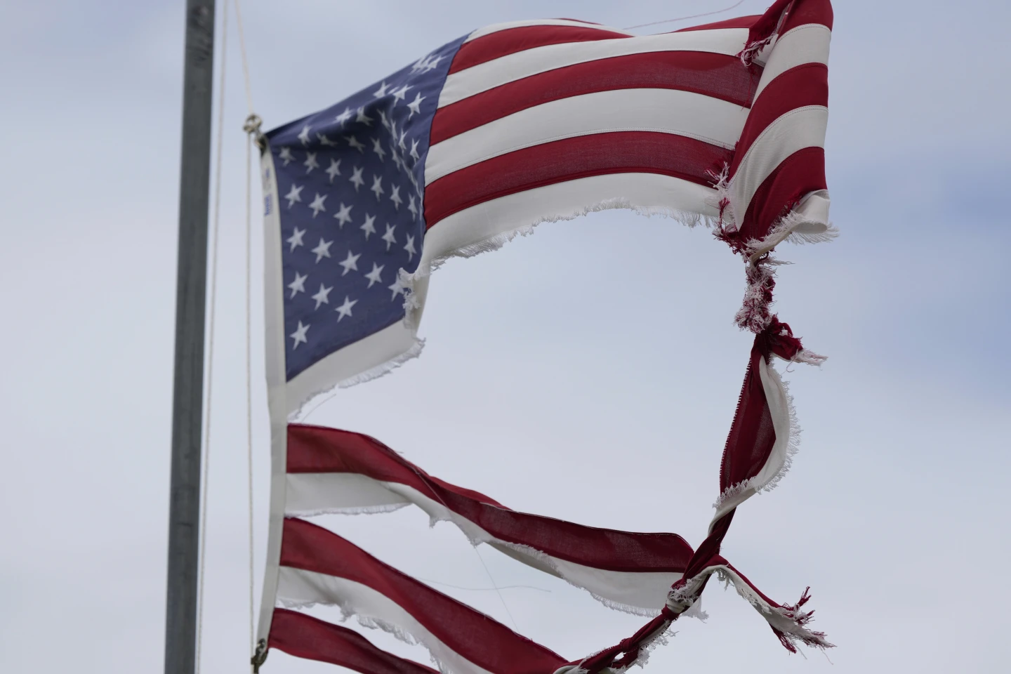 A tattered flag tips in the wind after Beryl moved through the area, Monday, 8 July 2024, in Matagorda, Texas. The National Hurricane Center said damaging winds and flash flooding would continue as Beryl continued pushing inland. Photo: Eric Gay / AP Photo