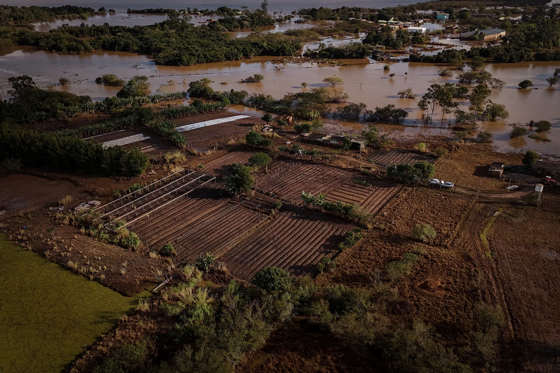 A drone view shows the flooded plantations, houses and streets of the Integracao Gaucha settlement in Eldorado do Sul, Rio Grande do Sul state, Brazil, 17 May 2024. Photo: Amanda Perobelli / REUTERS