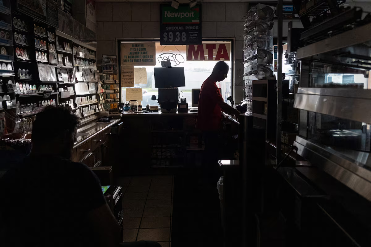 Seby Godinho, 50 and Jack Souza, 52, run a convenience store without electricity in the aftermath of Hurricane Beryl in Oyster Creek, Texas, U.S., 9 July 2024. Photo: Adrees Latif / REUTERS