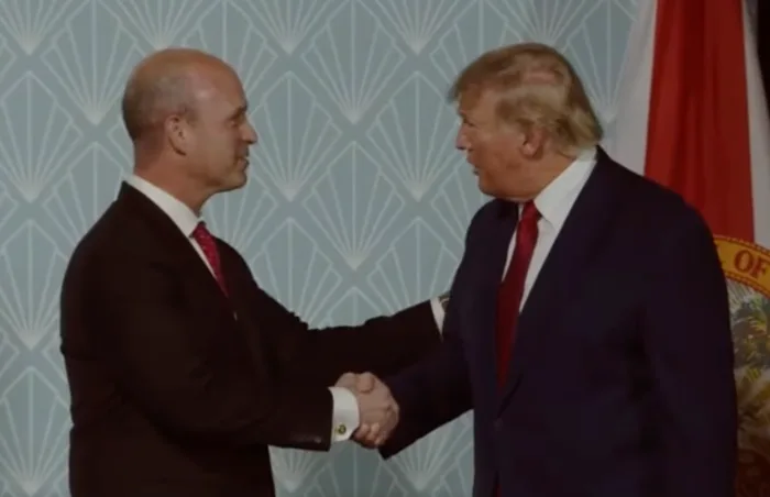 Trump shakes hands with Heritage Foundation president Kevin Roberts in April 2022. On 5 July 2024, Trump disavowed knowledge of the Heritage Foundation’s Project 2025 plan to turn the U.S. into an authoritarian state, but his denial was immediately exposed as a lie by multiple researchers. At least 140 people who worked for Trump are involved. Photo: Rumble