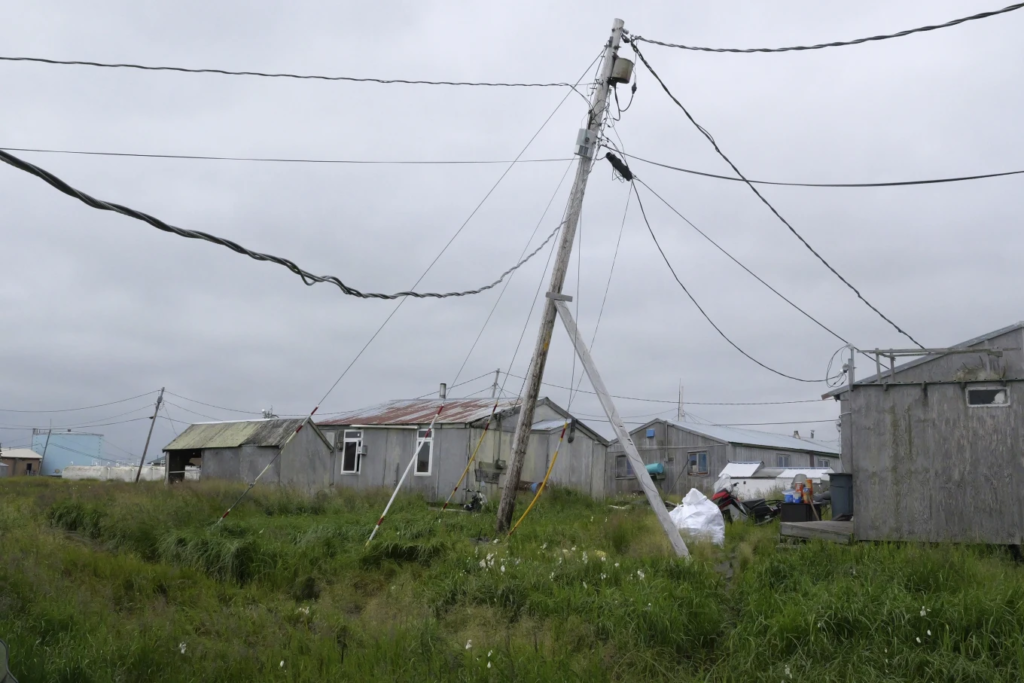 Power poles lean in the village of Newtok, Alaska on Wednesday, 14 August 2024. Photo: Rick Bowmer / AP