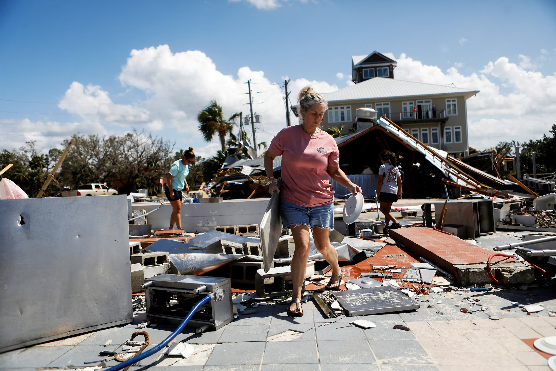 Nikki Wicker, co-owner of Roy's Restaurant, cleans after Hurricane Helene made landfall overnight, in Steinhatchee, Florida, 27 September 2024. Photo: Octavio Jones / REUTERS