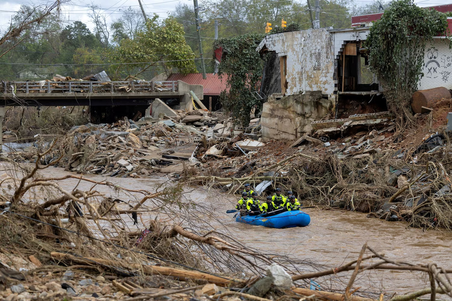 A rescue team paddles down the Swannanoa River after the remnants of Hurricane Helene caused widespread flooding, downed trees, and power outages in western North Carolina, 29 September 2024. Photo: Travis Long / The News and Observer / Reuters