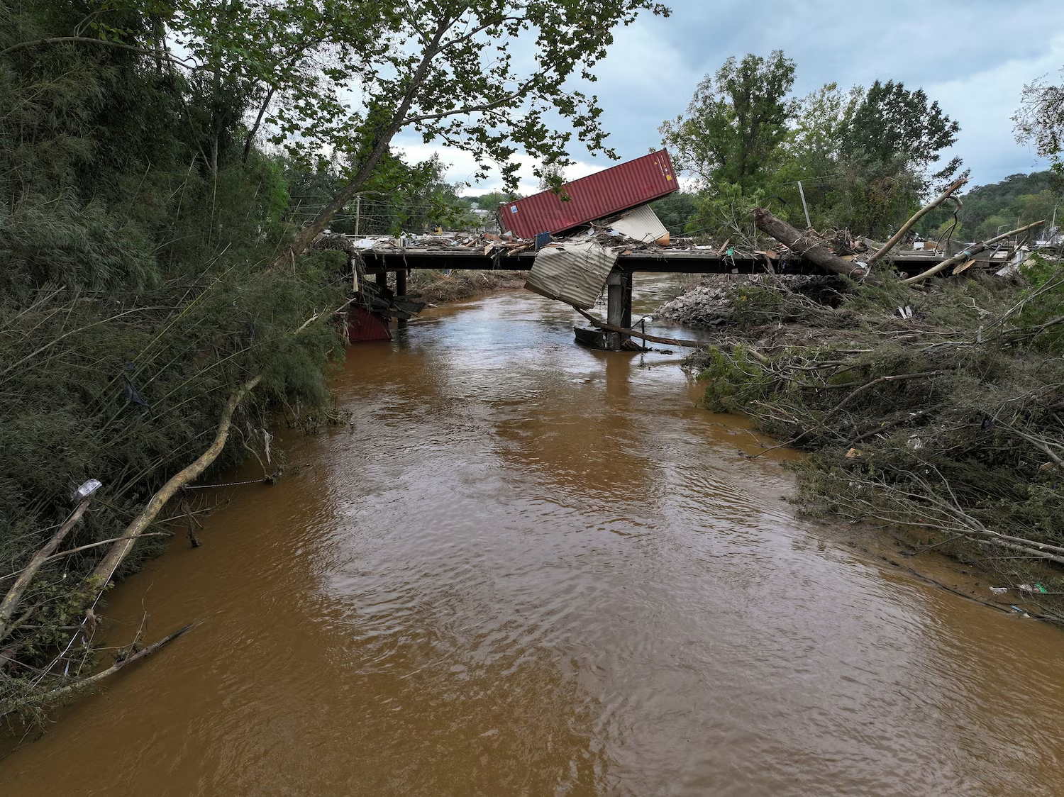 A shipping container is stranded on a bridge following the passing of Hurricane Helene, in Asheville, North Carolina, 29 September 2024. Photo: Marco Bello / Reuters