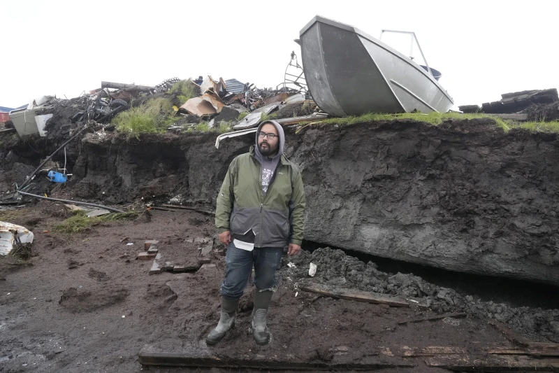 Calvin Tom, the tribal administrator, stands along the eroded coastline in Newtok, Alaska on Friday, 16 August 2024. Photo: Rick Bowmer / AP