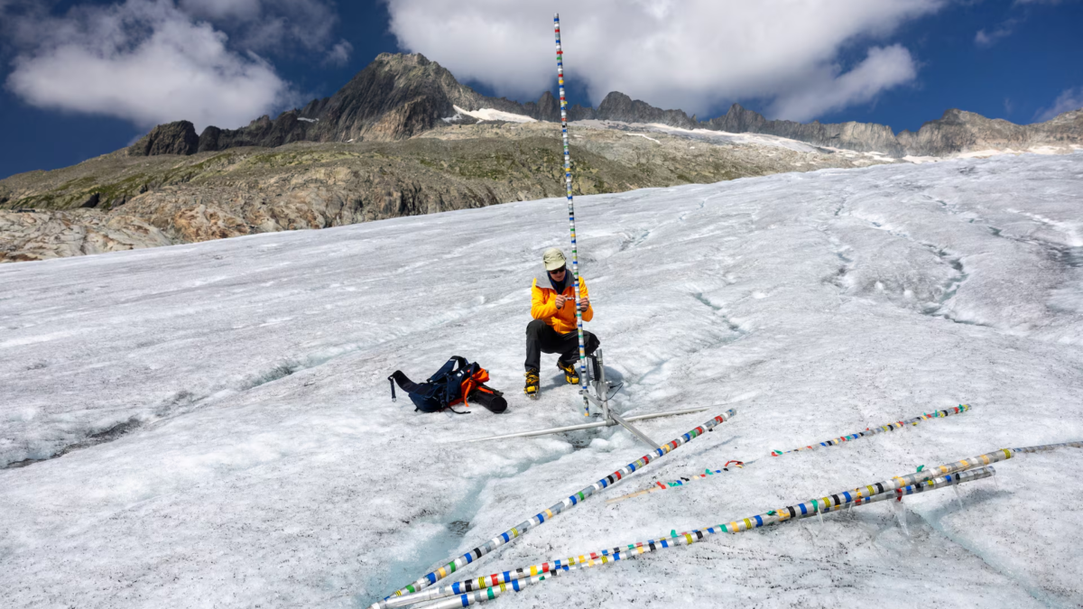 Glaciologist at ETH Zurich and Head of the Glacier Monitoring in Switzerland (GLAMOS) Matthias Huss check his equipment on the Rhone glacier amid climate change in Obergoms, Switzerland, 27 August 2024. Photo: Denis Balibouse / REUTERS