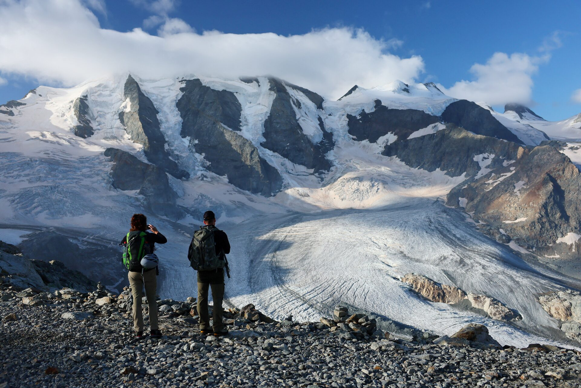 Hikers take a picture of Pers Glacier amid climate change, in Pontresina, Switzerland, 3 September 2024. Photo: Denis Balibouse / REUTERS