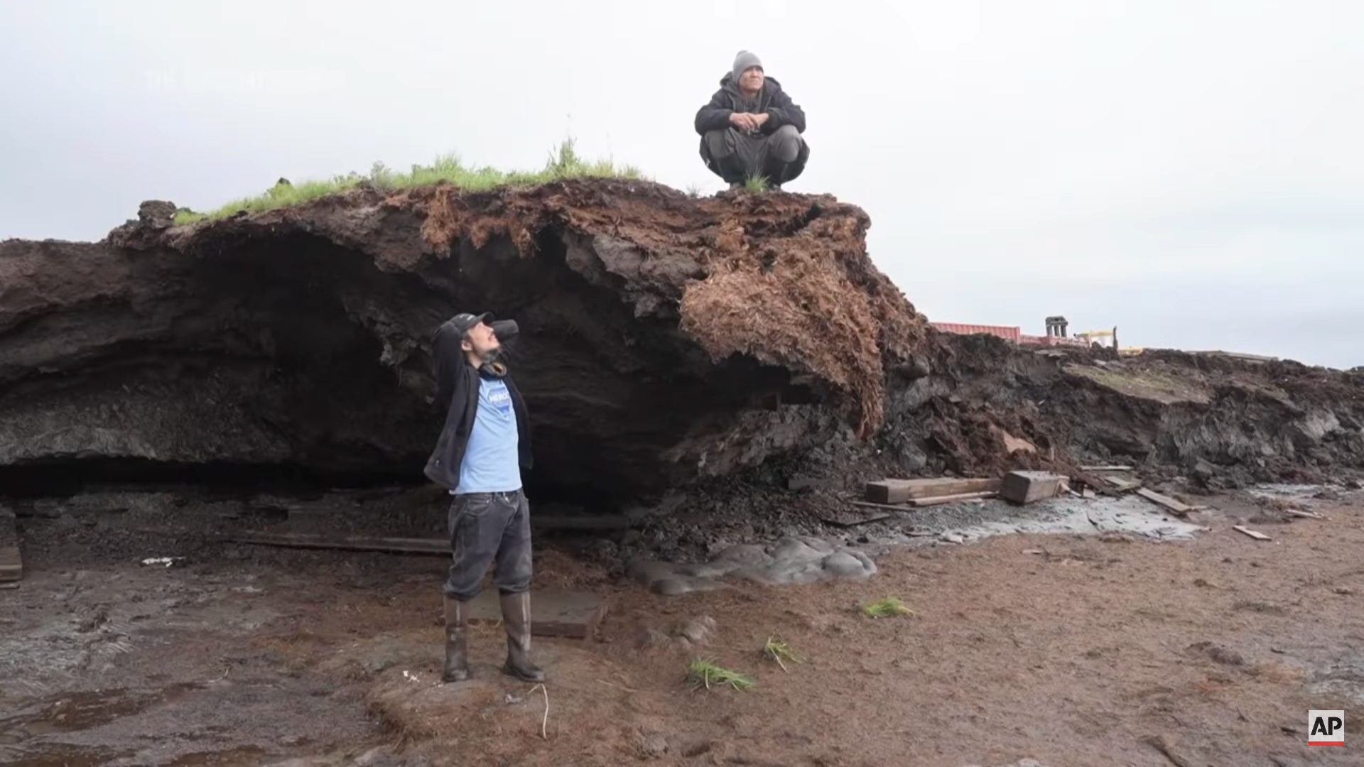 Charles Alexie and Gerald Tom near visible coastal erosion that encroaches on Newtok village in Alaska, on 16 August 2024. Erosion and melting permafrost have largely destroyed Newtok, eating about 70 feet (21.34 meters) of land every year. Photo: Rick Bowmer / AP